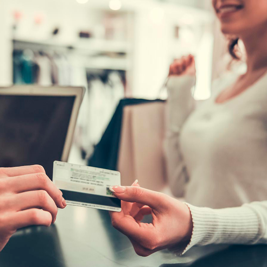 Mujer pagando sus compras con tarjeta Visa
